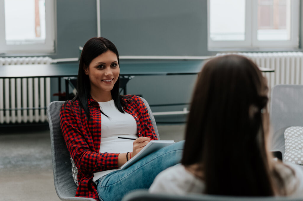 Job applicant having interview with female manager.